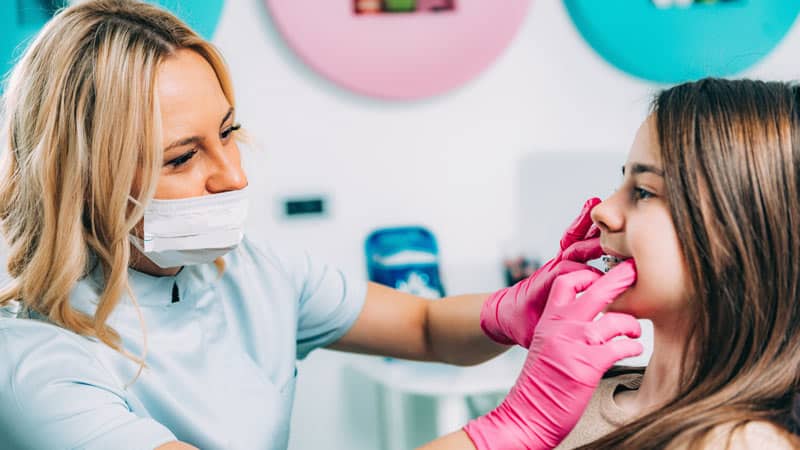 Woman checking childs braces Woman checking childs braces